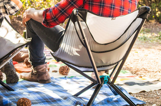 Man at campsite wearing red flannel sitting in cliq chair