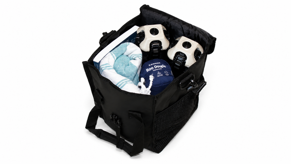 A black chair bag shown open on a white background, containing outdoor gear, ClassiQ chairs