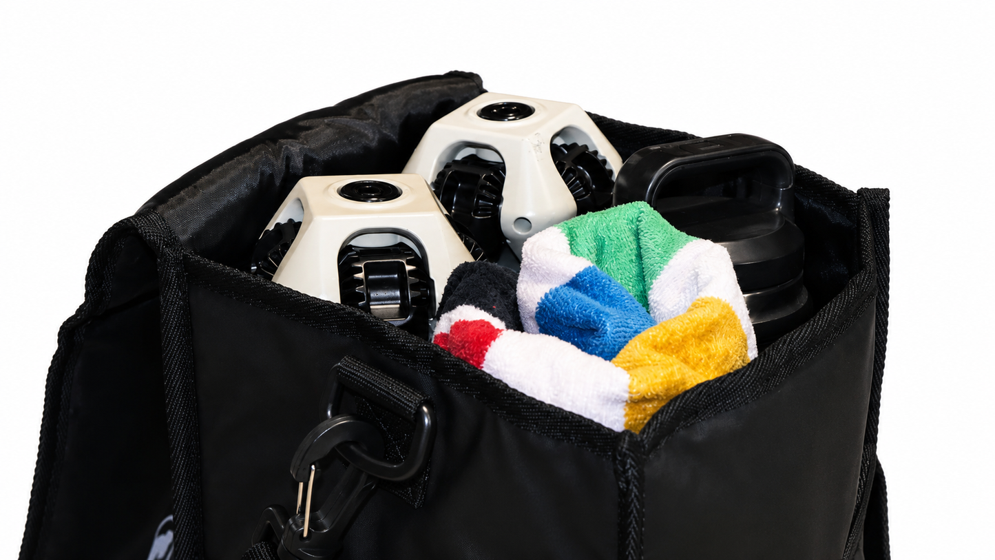 A black soft-sided bag shown open on a white background, filled with two ClassiQ chairs, a black bottle, and a folded multicolor towel.