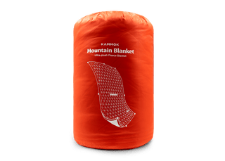 Kammok Mountain Blanket packed in its Ember Orange stuff sack