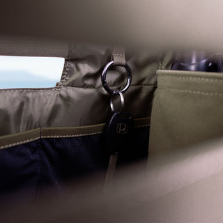 Keychain attached to a ToQ bag with a neutral background