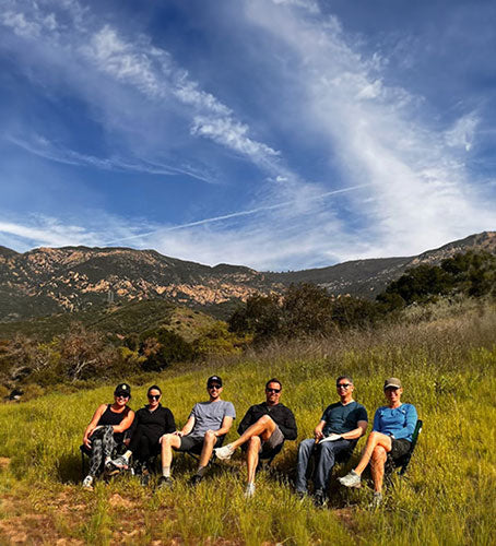 Founders sitting on Cliq chairs in nature